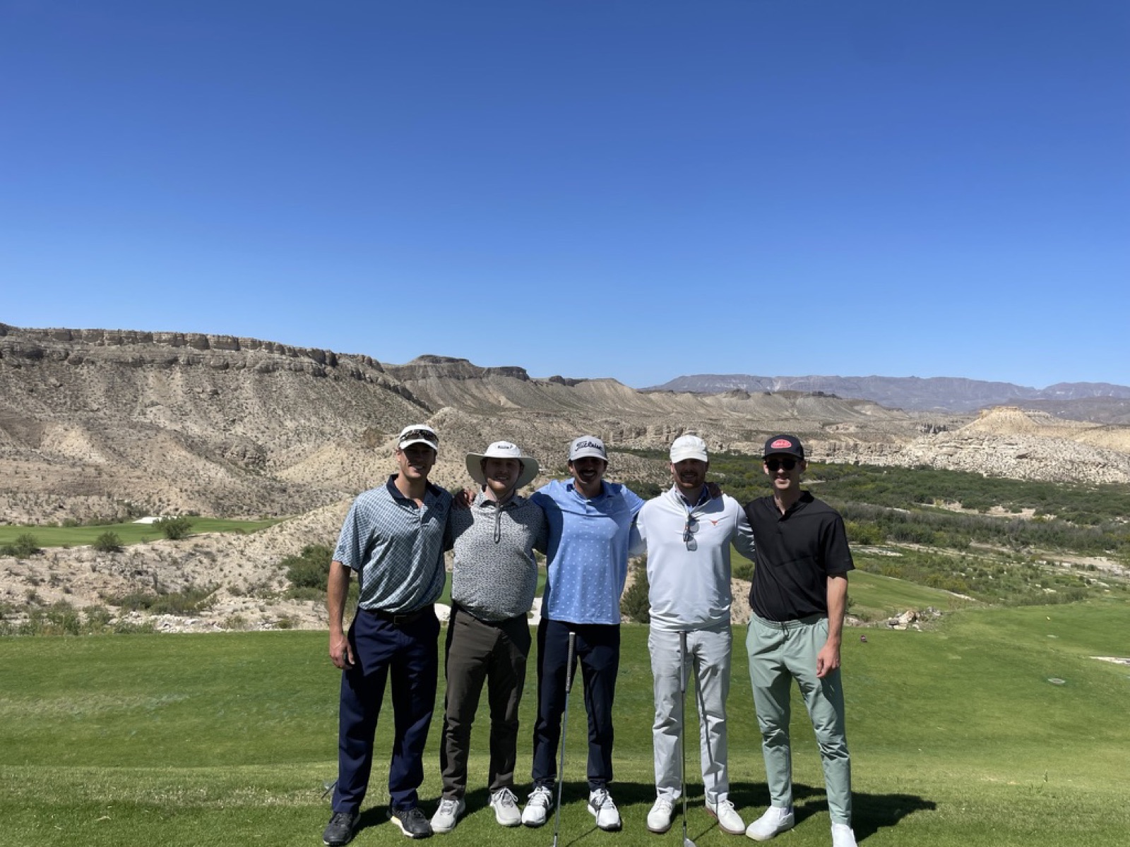 Noah with four friends on a golf course in the desert