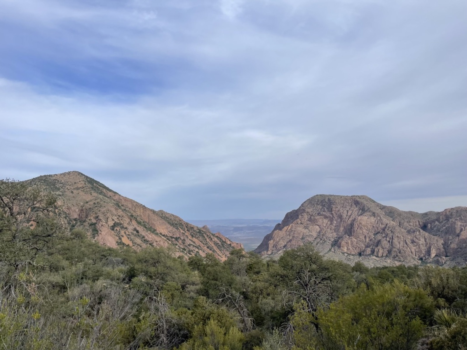 Rugged desert mountains under a cloudy sky